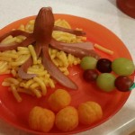 Octopus atop barnacles, cannon cheese balls, and fruit on a pirate sword